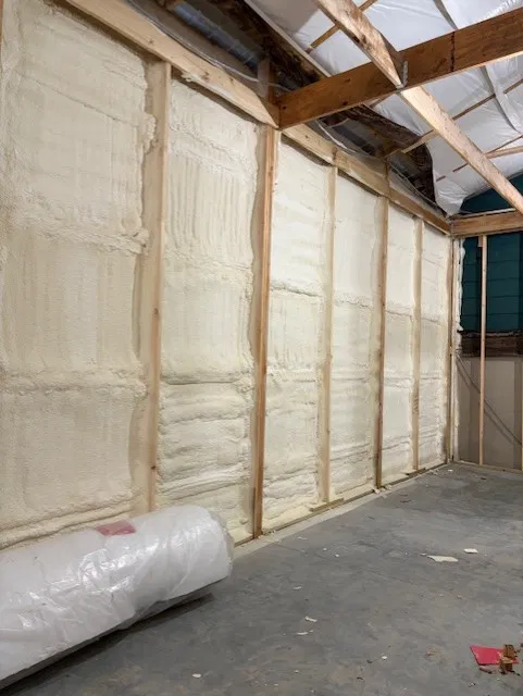 Finished wall with every stud bay filled with closed-cell spray foam insulation